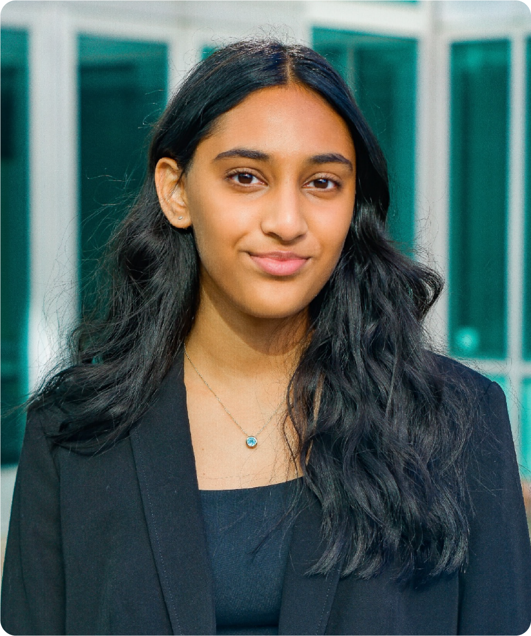 A color photo of a woman smiling for a photo.
