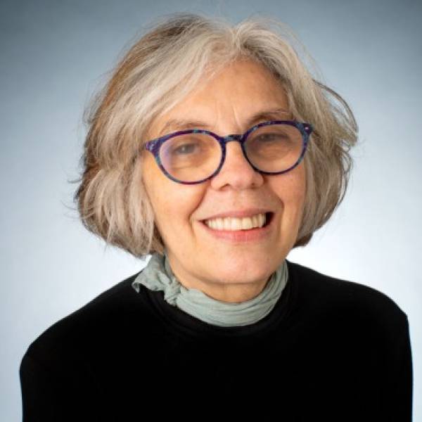 A color photo of a woman smiling for a photo