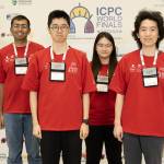 A color photo showing 4 people smiling for a photo at the ICPC World Finals